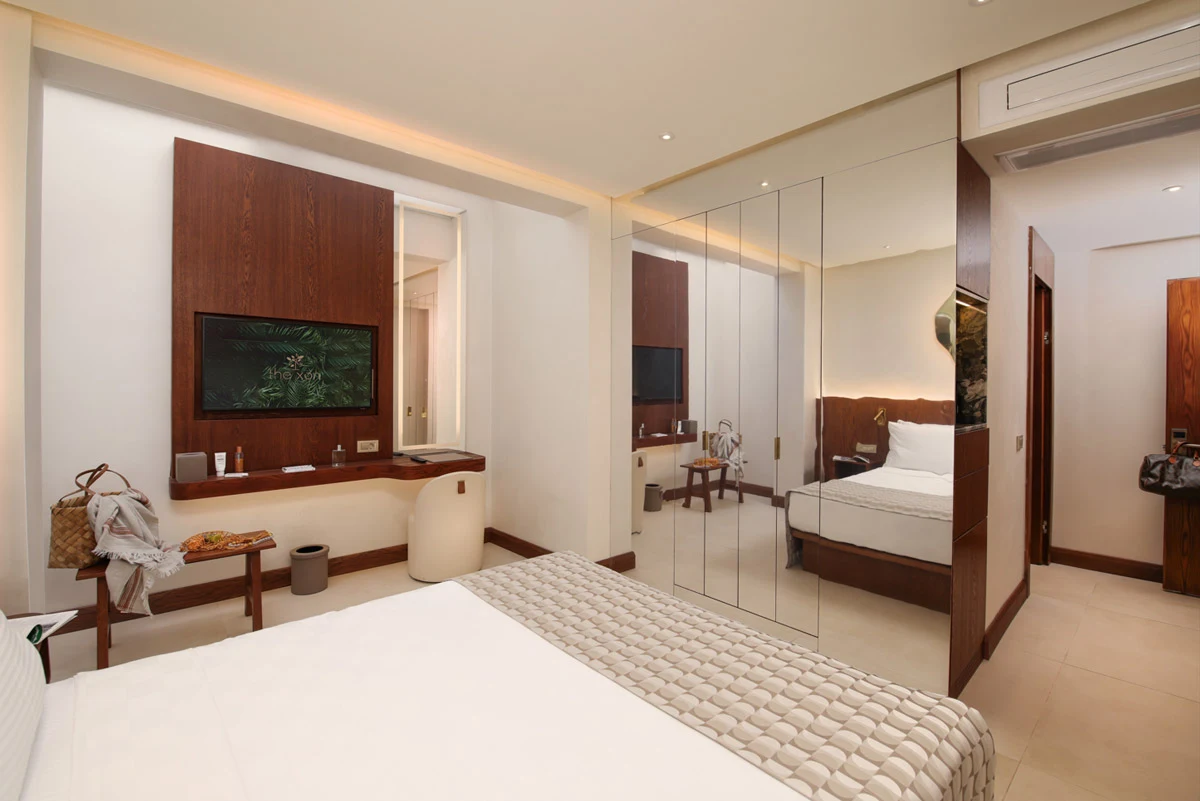 The Xon Hotel — Bed and seating area in a hotel room