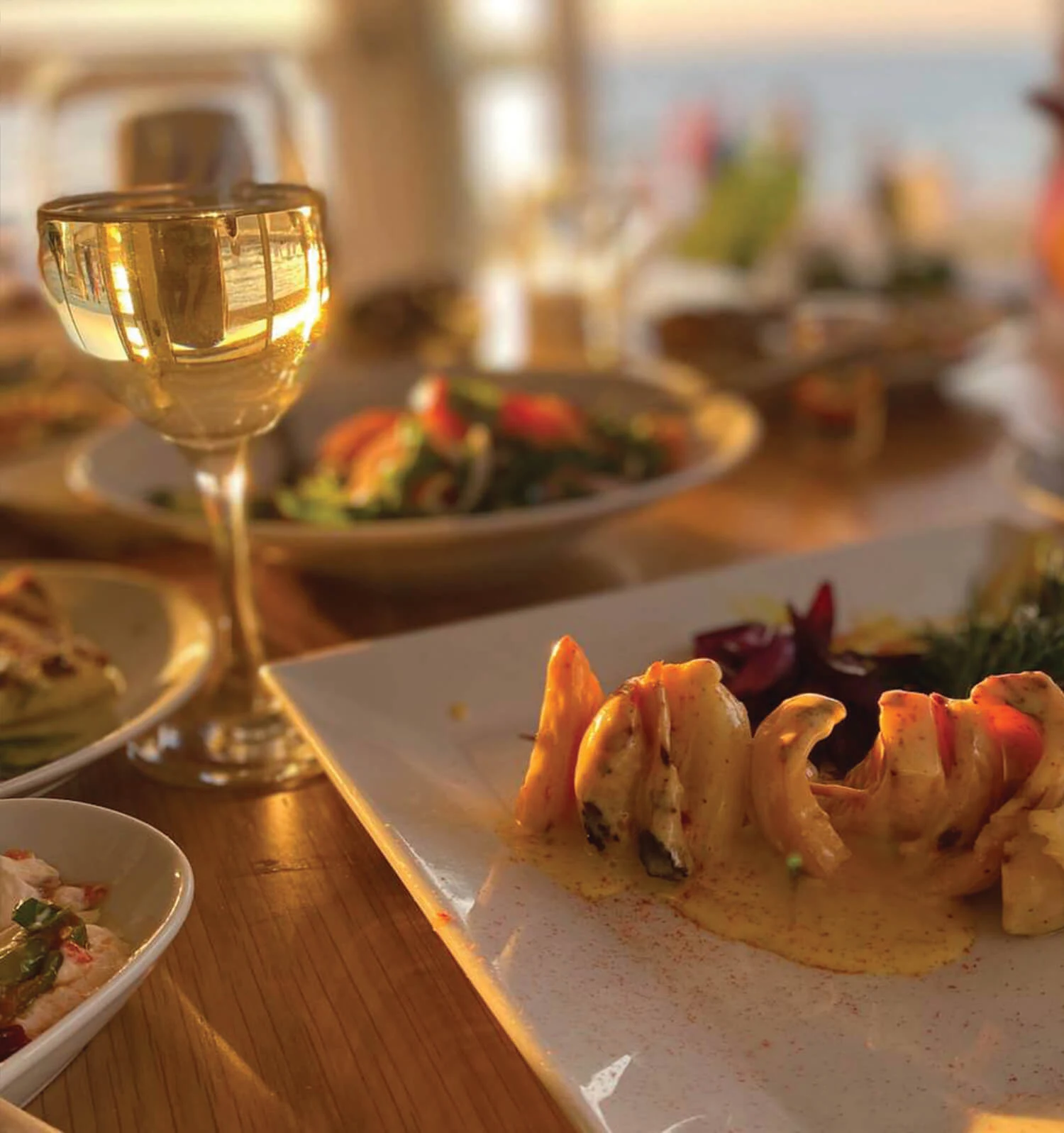 Salonis Restoran — A table with food and a sea view