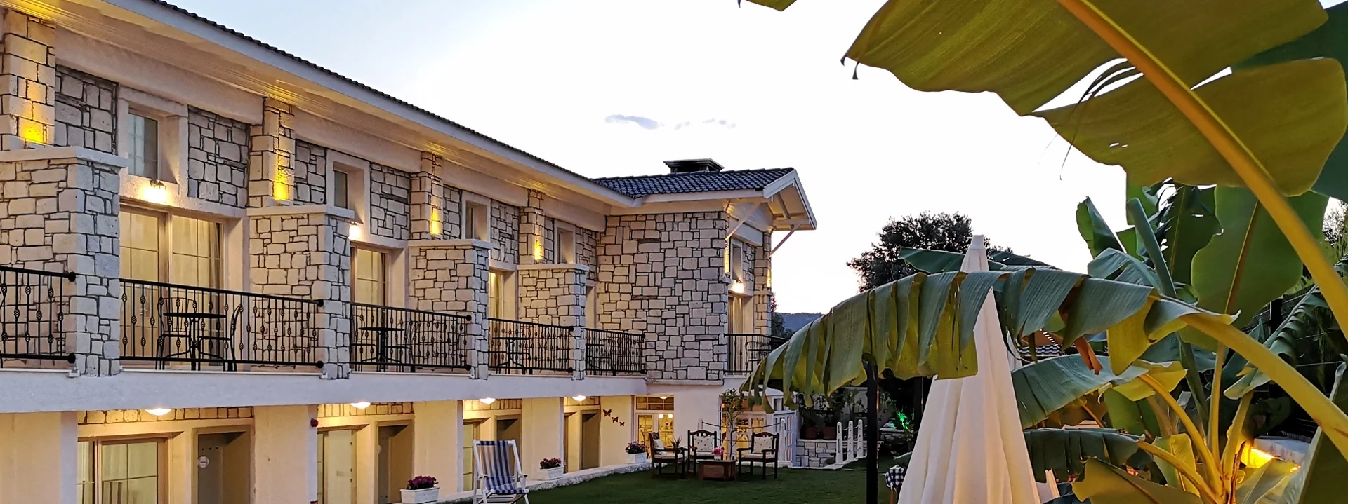 Duman Butik Otel — The hotel’s stone facade and garden