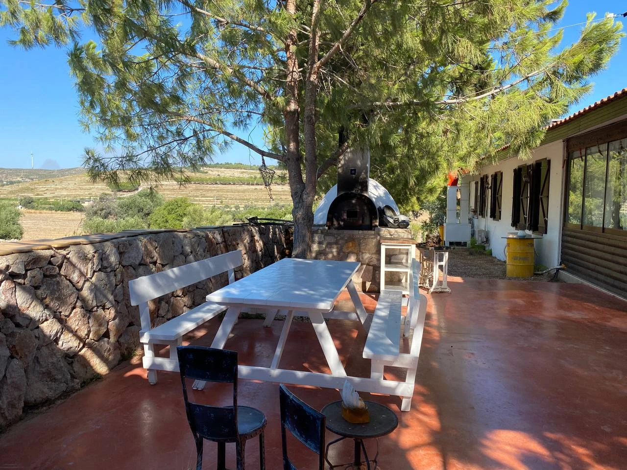 Noni’s House — Seating beside a stone wall